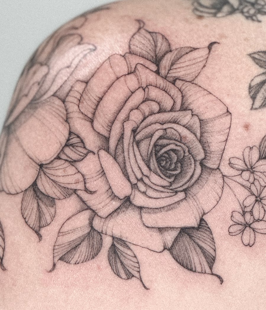 A delicate black and grey rose bouquet tattoo on the shoulder with fine line detailing — by Melanie Benoit, los angeles