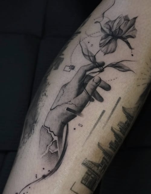 A black and grey fine line tattoo on the forearm depicting a hand holding a flower with intricate details and delicate shading — by Jian Liang, los angeles