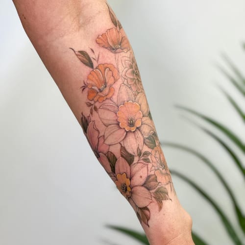 A delicate floral bouquet tattoo on the forearm featuring fine line work and soft colors — by Melanie Benoit, los angeles