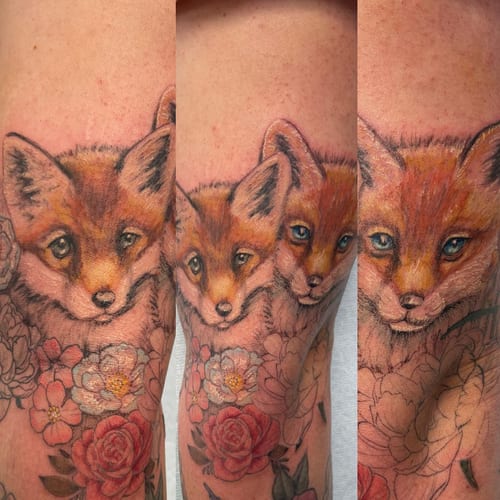 A realistic and colorful fox tattoo surrounded by flowers on the forearm, featuring detailed fur and vibrant colors — by Sandra Price, los angeles