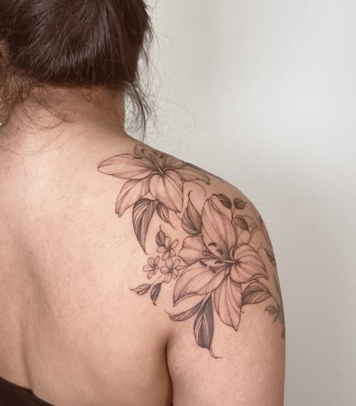 A delicate black and grey floral bouquet tattoo on the shoulder with fine line details — by Melanie Benoit, los angeles