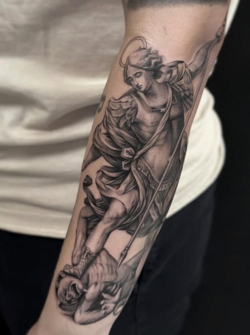 A detailed black and grey realism tattoo of Archangel Michael defeating a demon on the forearm, showcasing intricate shading and dynamic composition — by Jian Liang, los angeles