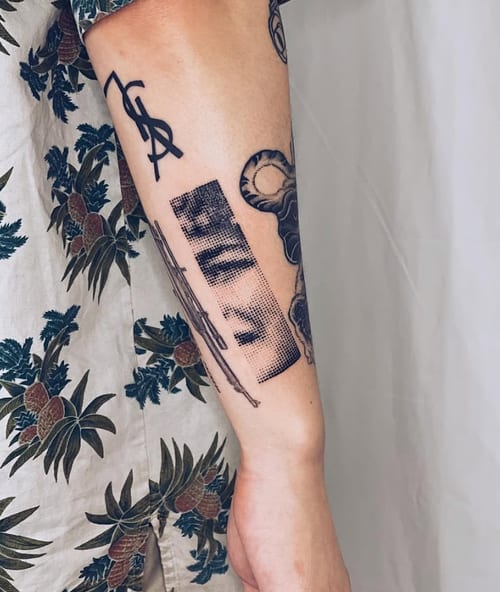 A black and grey dotwork tattoo on the forearm featuring a barcode design with script elements, showcasing intricate linework — by Level tattoo, los angeles