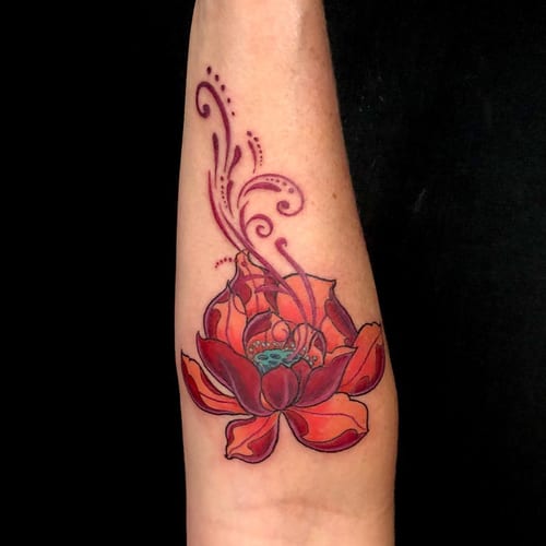A colorful ornamental lotus flower tattoo on the forearm with delicate illustrative details — by Sandra Price, los angeles