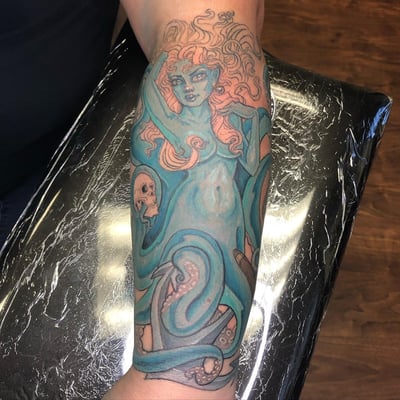 A colorful neo-traditional tattoo on the forearm depicting a mythological woman entwined with an octopus and a skull — by Sandra Price, los angeles