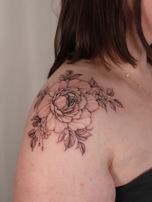 A delicate black and grey floral bouquet tattoo on the shoulder, featuring fine line work and intricate details — by Melanie Benoit, los angeles