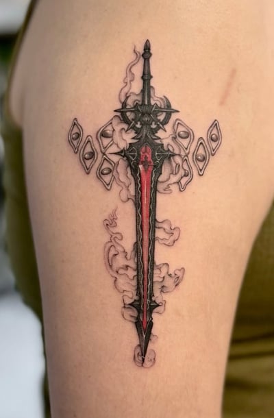 A Neo-Traditional tattoo of a sword with intricate details and smoke-like elements on the upper arm, featuring a mix of black and red ink — by otaybeatdown, los angeles
