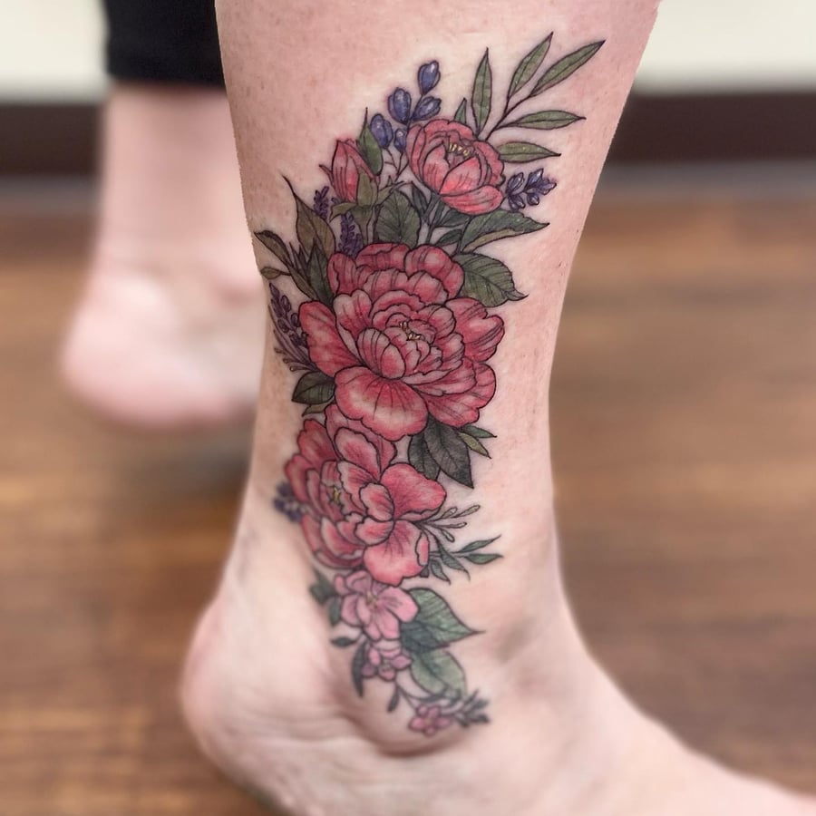 A colorful floral bouquet tattoo on the ankle featuring detailed flowers and leaves in a delicate style — by Sandra Price, los angeles