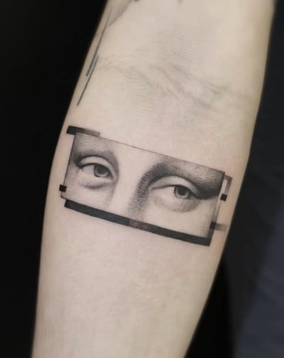 A black and grey fine line tattoo on the forearm depicting a pair of eyes in a rectangular frame with a minimalist style — by Jian Liang, los angeles