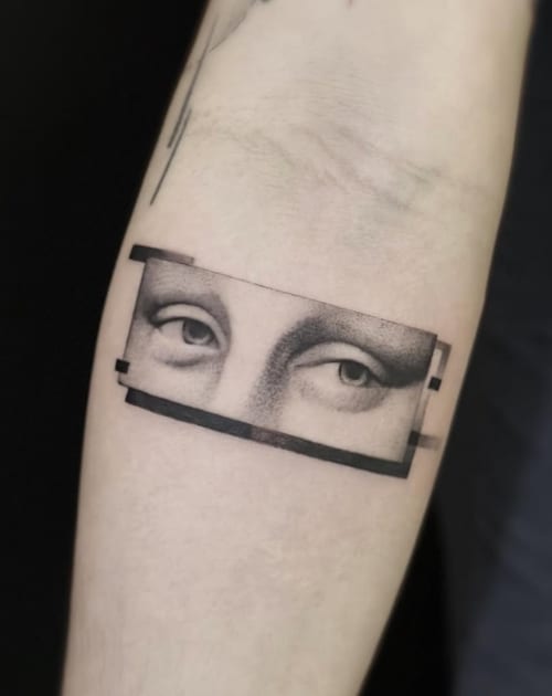 A black and grey fine line tattoo on the forearm depicting a pair of eyes in a rectangular frame with a minimalist style — by Jian Liang, los angeles