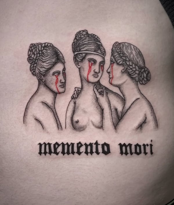 A black and grey tattoo of three women with red tears, accompanied by the phrase 'memento mori' in bold lettering — by Shelby Bianco, ventura, ca
