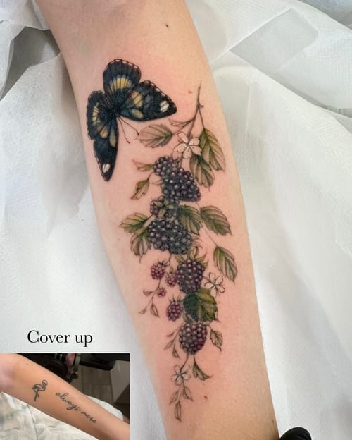 A delicate color tattoo of a butterfly and blackberry vine on the forearm, featuring realistic floral details — by Melanie Benoit, los angeles
