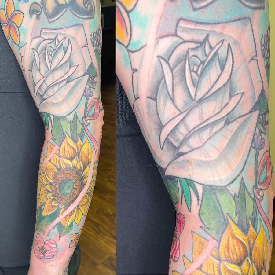 A colorful neo-traditional tattoo featuring a rose and sunflower on the arm, with bold outlines and vibrant colors — by Sandra Price, los angeles