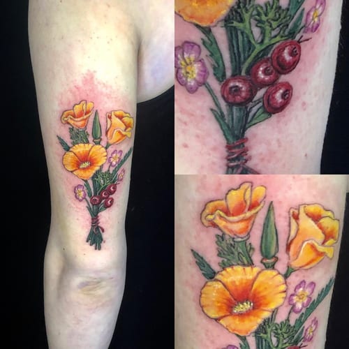 A colorful neo-traditional bouquet of flowers tattoo on the upper arm, featuring vibrant orange and purple blooms — by Sandra Price, los angeles