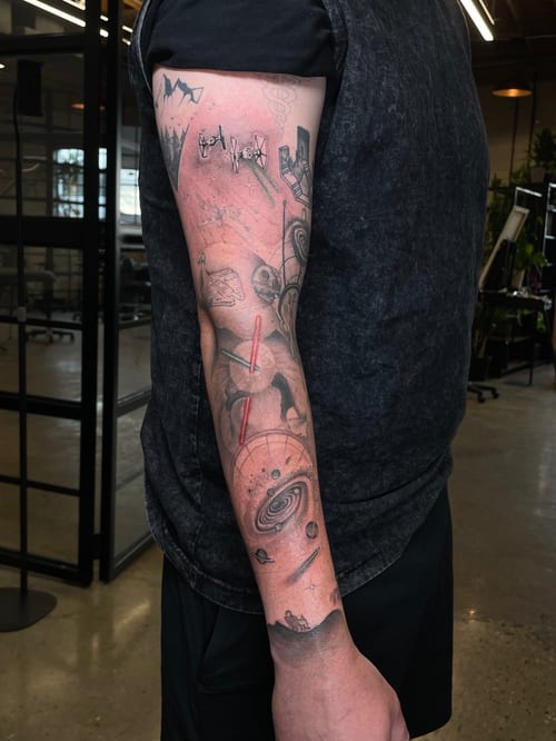black & grey space scene with planets and astronaut tattoo — by Vince Espinoza, los angeles