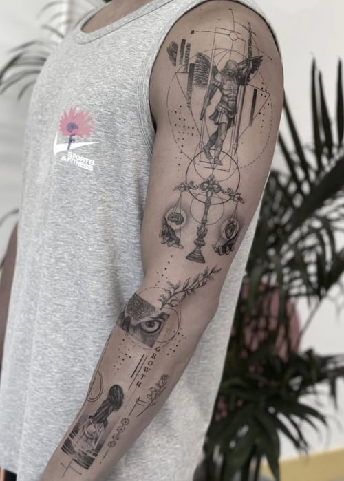 A detailed black and grey fine line tattoo on the arm featuring an angel, an eye, and scales, with intricate dotwork and geometric elements — by Jian Liang, los angeles