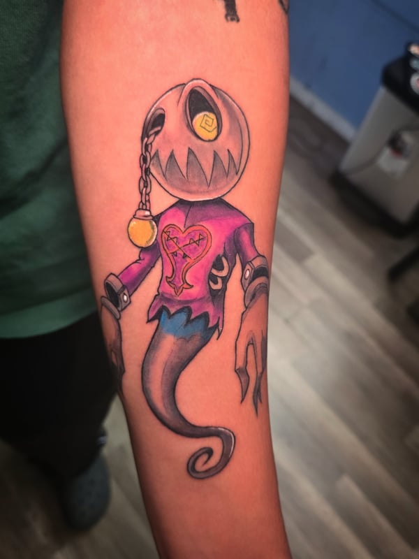 A colorful New School tattoo of a pumpkin-headed ghost with a whimsical design on the forearm, featuring vibrant colors and bold outlines — by Dretty, long beach, ca