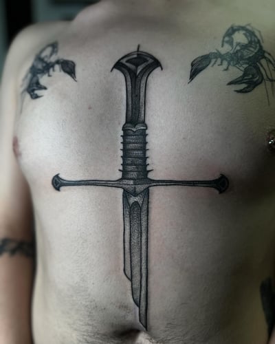A bold blackwork sword tattoo on the stomach with detailed linework — by Maddie Ramirez, los angeles
