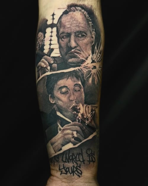 Realistic black and grey portraits of two men on the forearm, featuring detailed facial expressions and script lettering — by zealous, los angeles