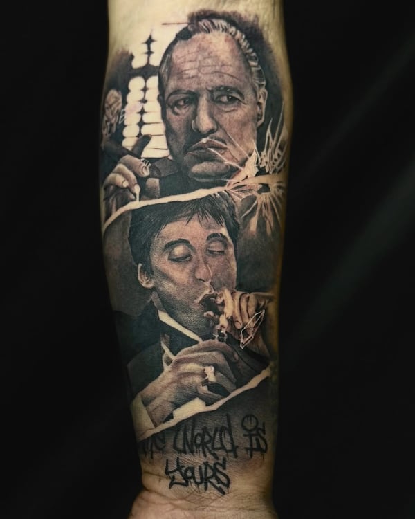 Realistic black and grey portraits of two men on the forearm, featuring detailed facial expressions and script lettering — by zealous, los angeles