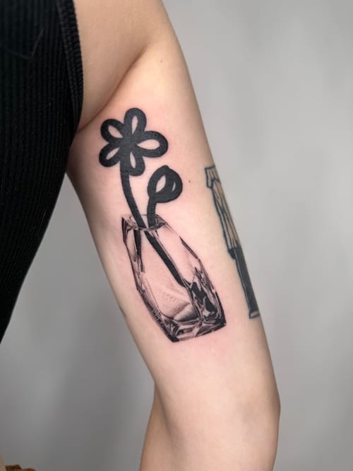 minimalist flower in a vase tattoo — by Level tattoo, los angeles