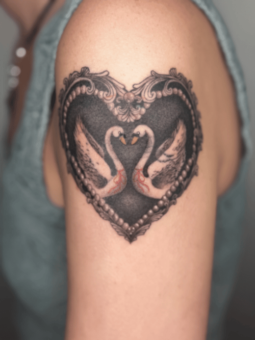 black & grey two swans forming a heart tattoo — by Samantha Wilks, los angeles