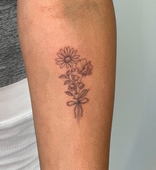 A delicate black and grey fine line flower bouquet tattoo on the arm, featuring a minimalist design — by Melanie Benoit, los angeles