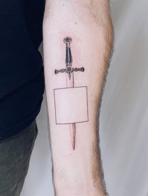 A minimalist black and grey fine line tattoo of a sword on the forearm, featuring clean lines and simple design — by Level tattoo, los angeles