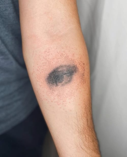 A black and grey dotwork tattoo of an eye on the forearm, featuring intricate dot shading and a minimalist design — by Level tattoo, los angeles