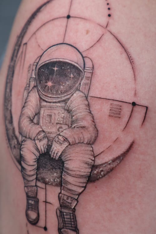 blackwork astronaut sitting on moon tattoo — by Vince Espinoza, los angeles