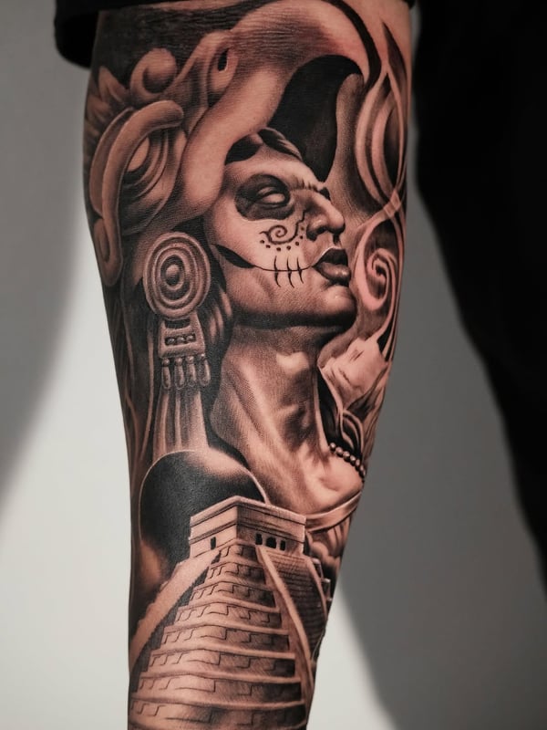 A bold black and grey tattoo of a Mayan warrior with a temple on the leg, featuring realistic shading and intricate details — by Johnny Ayala, fontana, ca