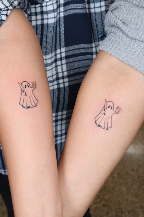 minimalist ghost holding a coffee cup tattoo — by Vince Espinoza, los angeles