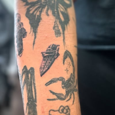 A small black and grey dagger tattoo on the forearm in blackwork style — by Maddie Ramirez, los angeles