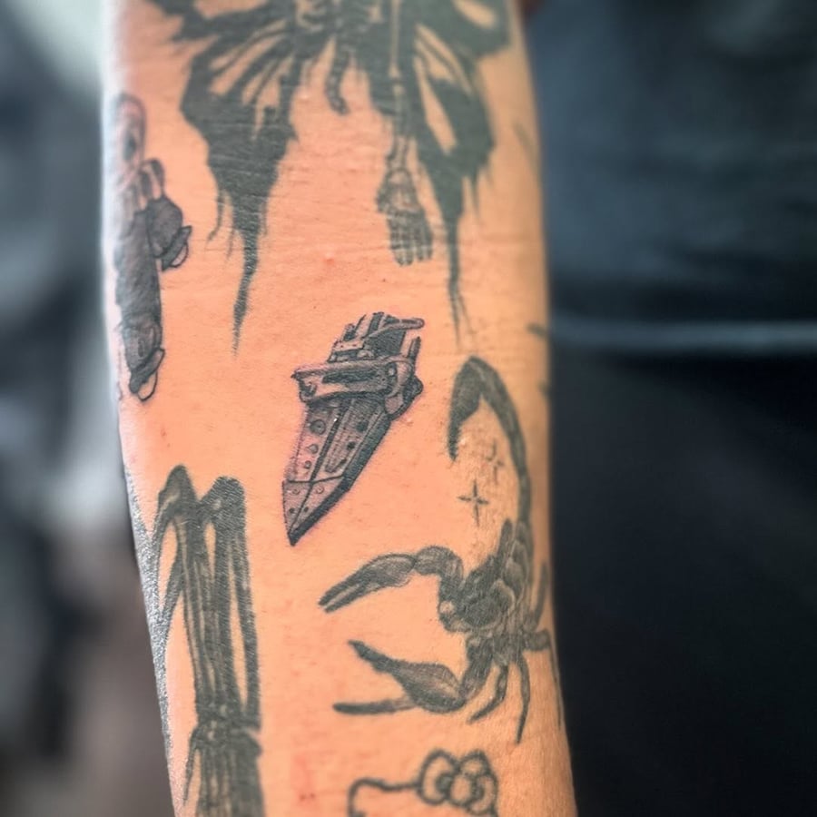 A small black and grey dagger tattoo on the forearm in blackwork style — by Maddie Ramirez, los angeles