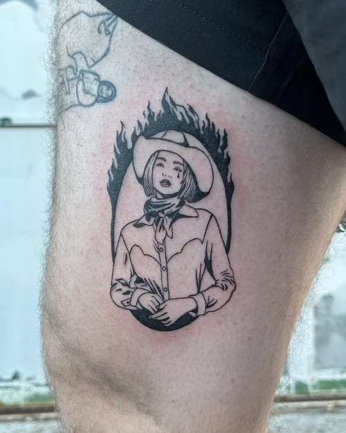 A bold blackwork cowgirl portrait tattoo on the thigh with strong linework and illustrative style — by Dylan Aiello, los angeles