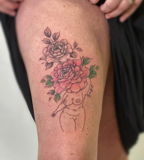 A delicate tattoo of a nude woman with flowers for a head, featuring fine line work and colorful floral elements on the thigh — by Melanie Benoit, los angeles