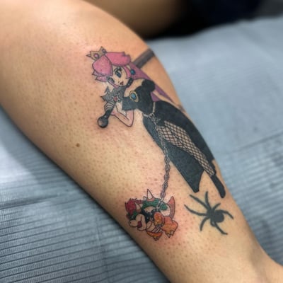 A colorful anime-style character with a sword and chain on the leg, featuring blackwork and a spider design — by Maddie Ramirez, los angeles