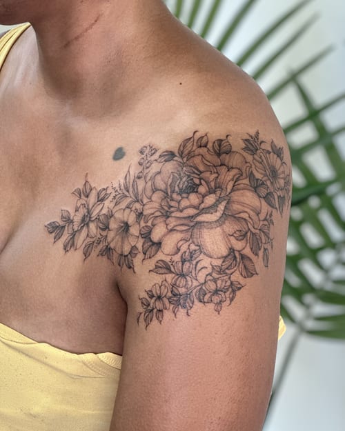 A delicate black and grey floral bouquet tattoo on the shoulder with intricate detailing — by Melanie Benoit, los angeles