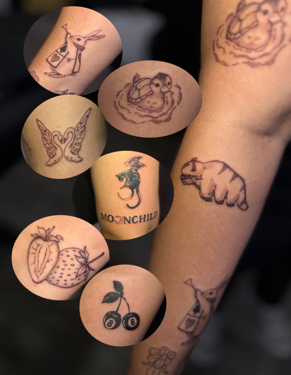 Various small black and grey tattoos on the arm, including animals, fruit, and script — by Maddie Ramirez, palm desert, ca