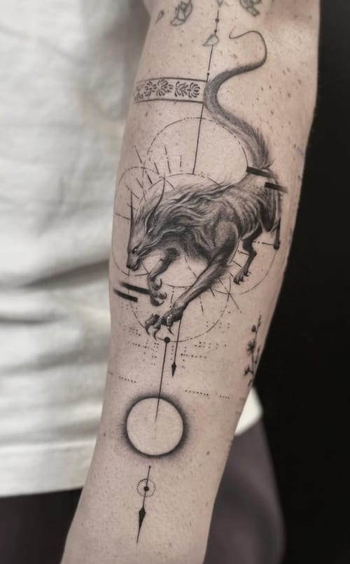 A black and grey tattoo of a wolf in motion on the forearm, featuring geometric and dotwork elements for a dynamic and intricate design — by Jian Liang, los angeles