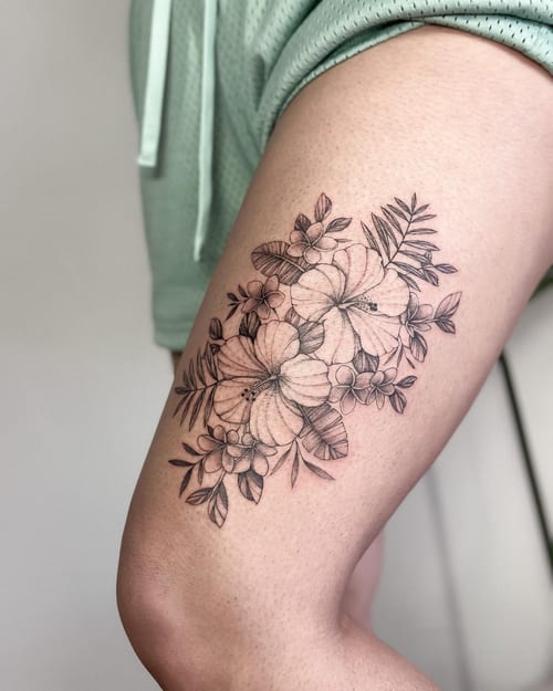 A delicate black and grey floral bouquet tattoo on the thigh, featuring fine line work and intricate details — by Melanie Benoit, los angeles