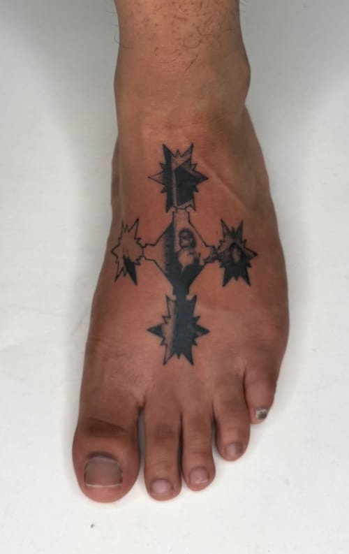 A minimalist blackwork tattoo on the foot featuring abstract star shapes connected by lines — by Level tattoo, los angeles