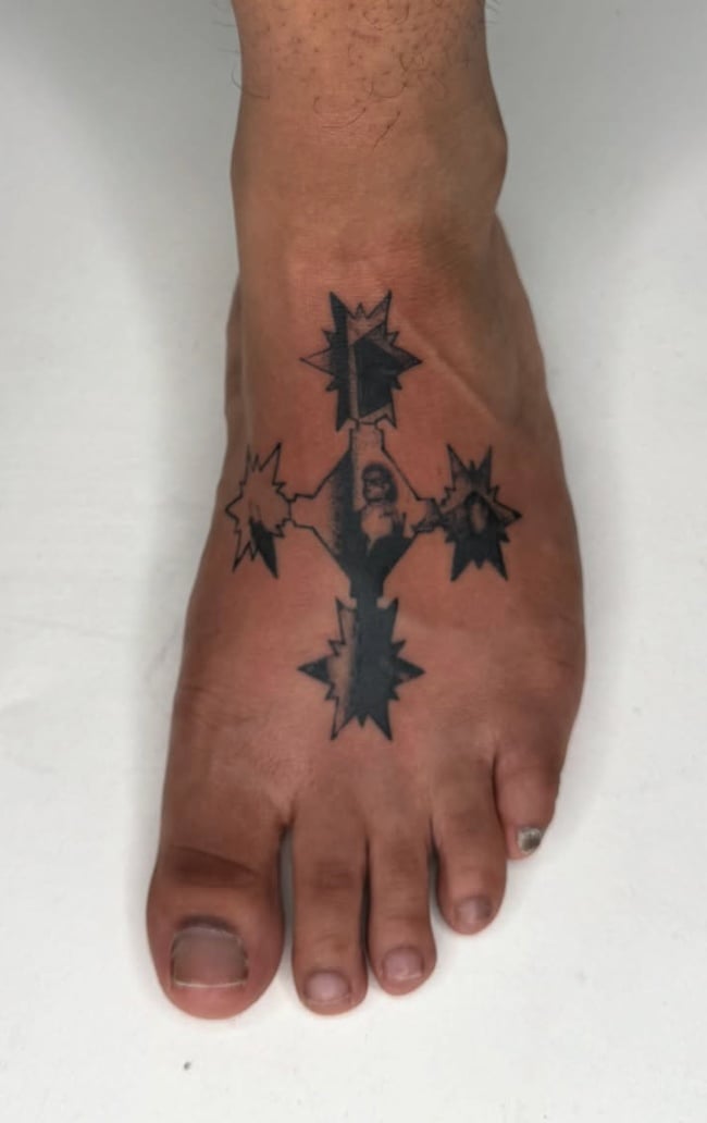 A minimalist blackwork tattoo on the foot featuring abstract star shapes connected by lines — by Level tattoo, los angeles