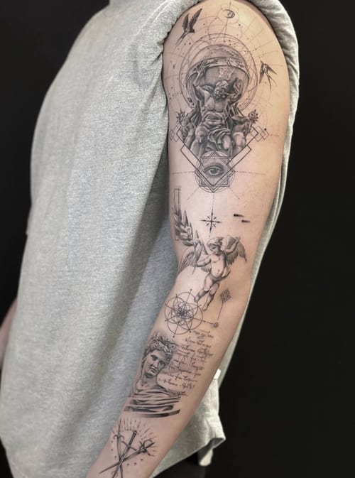 A black and grey surrealistic tattoo on the arm featuring an eye, an angel, and intricate geometric patterns with fine line details and script — by Jian Liang, los angeles