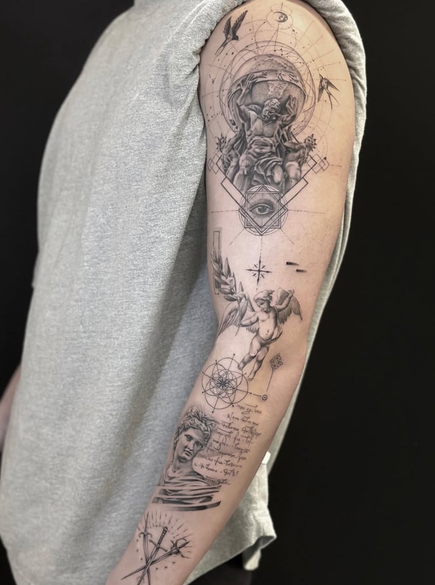 A black and grey surrealistic tattoo on the arm featuring an eye, an angel, and intricate geometric patterns with fine line details and script — by Jian Liang, los angeles
