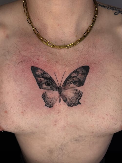 blackwork butterfly with eyes tattoo — by Level tattoo, los angeles