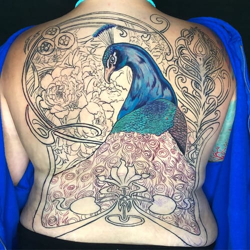 A colorful peacock tattoo on the back with intricate ornamental and floral elements, featuring a mix of color and black linework — by Sandra Price, los angeles
