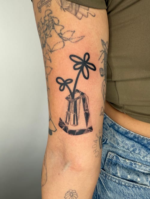 linework flowers in a vase tattoo — by Level tattoo, los angeles