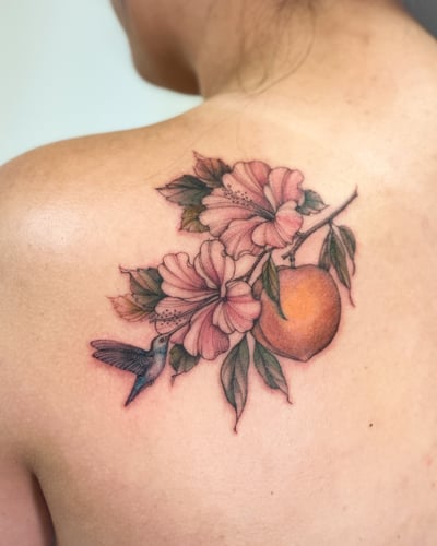 A delicate and colorful tattoo of a hummingbird with flowers and fruit on the back, featuring realistic details and a romantic style — by Melanie Benoit, los angeles