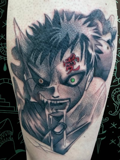 An anime-inspired black and grey tattoo on the leg, featuring a character's intense face with a glowing green eye and red symbol on the forehead — by Josue Bravo, los angeles
